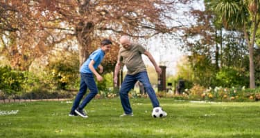 Photograph showing two men playing football.