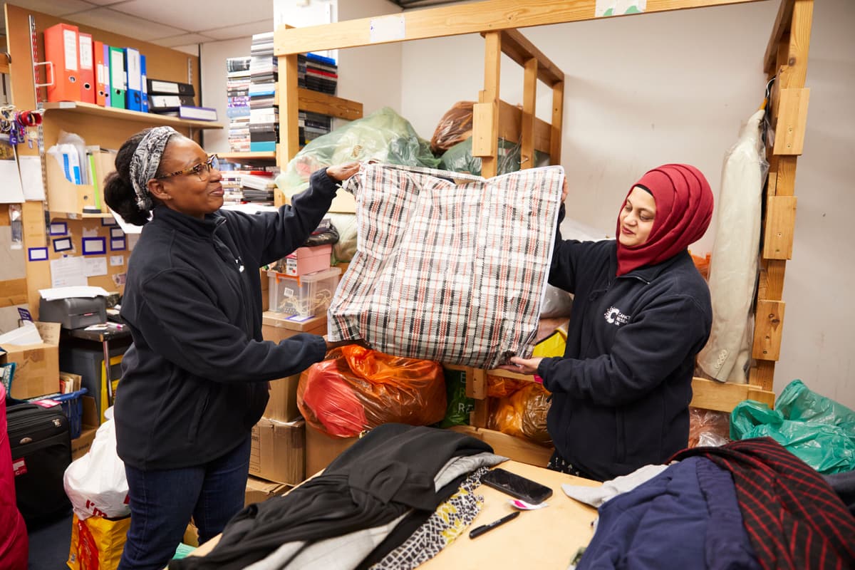 Image of two volunteers sorting stock.