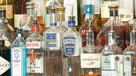 Bottles of alcohol on a shelf in a bar.