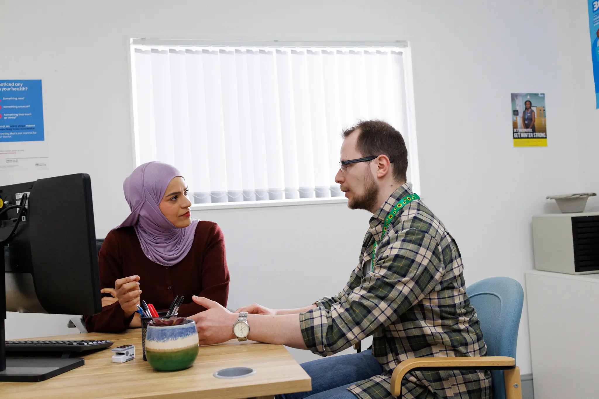 Photograph showing a doctor and patient in conversation.