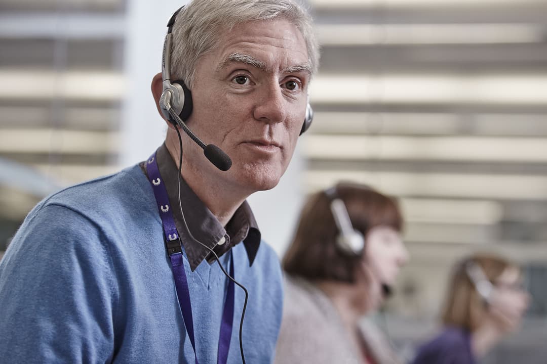 Helpline worker wearing a headset.