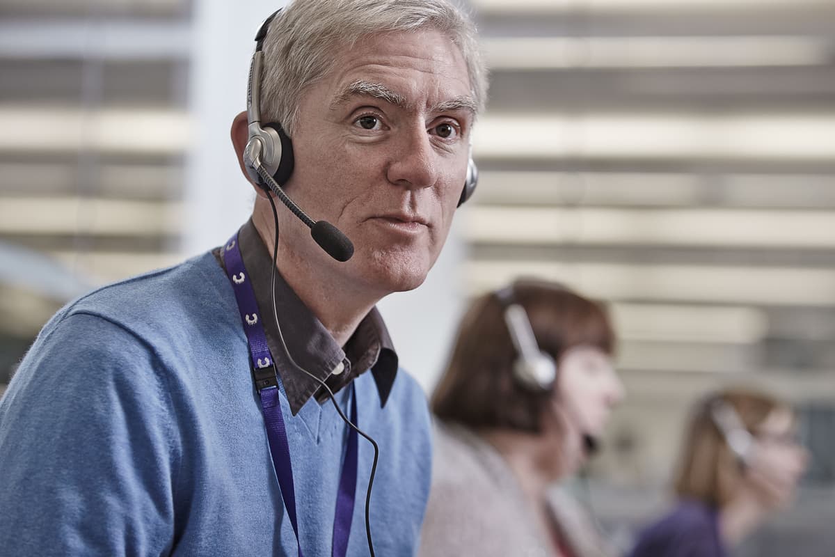 Helpline worker wearing a headset.