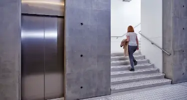 Photograph showing a woman climbing stairs.