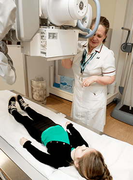 Photograph of Child having a chest x-ray.
