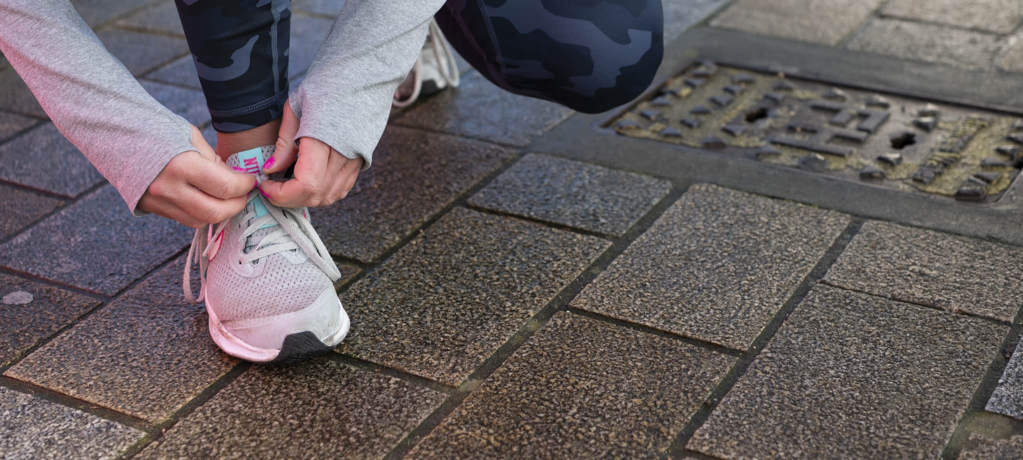 Person wearing glowing heart-shaped headband and colourful lights at a night event.