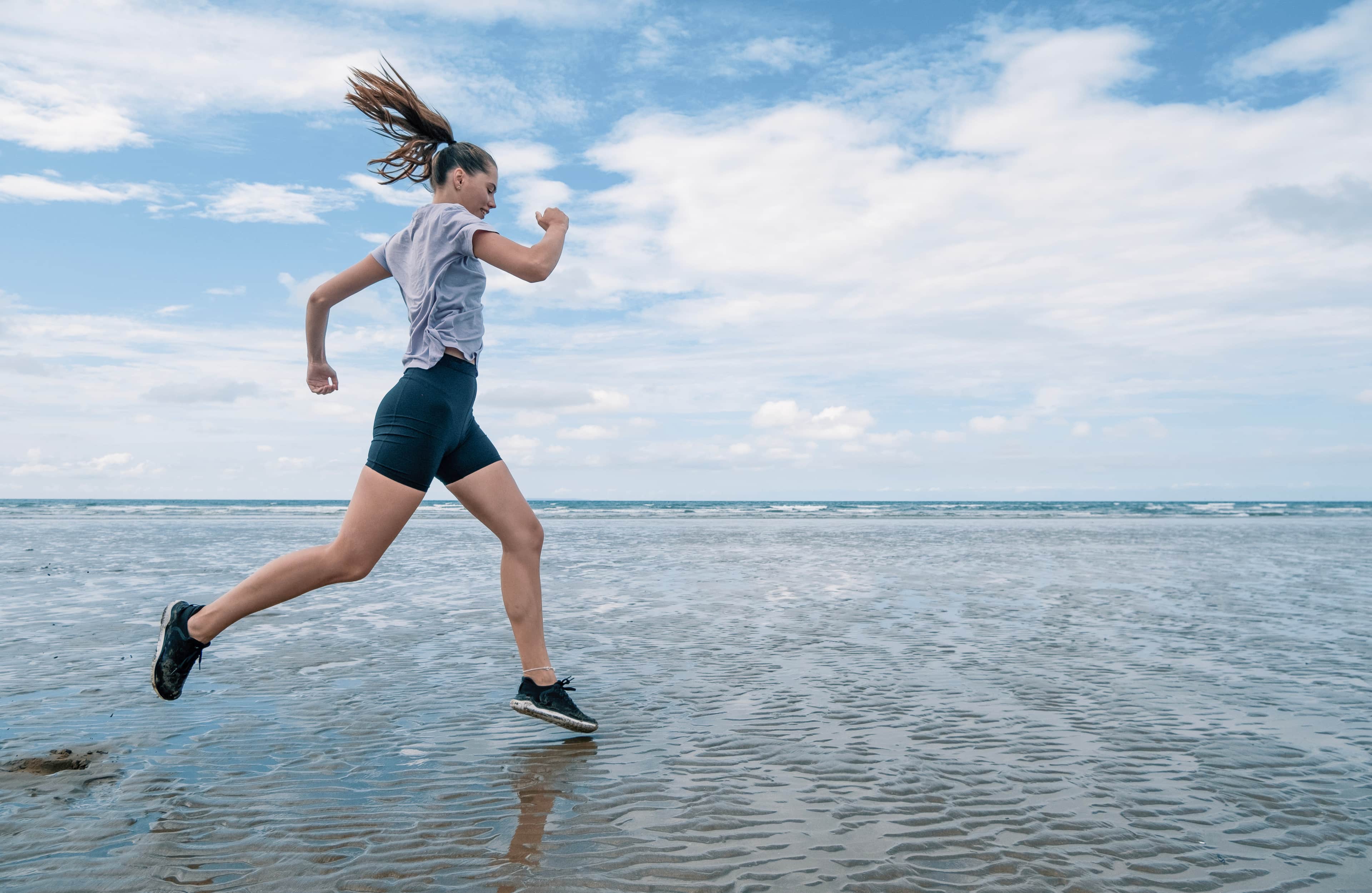 Woman running on a beach.