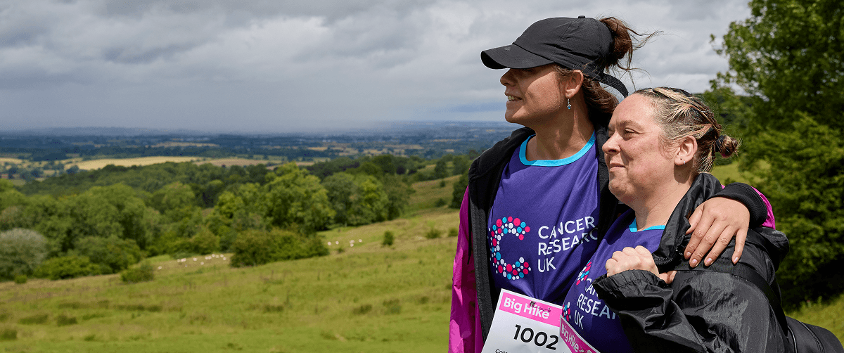 Two Big Hike participants hugging and looking at the horizon.