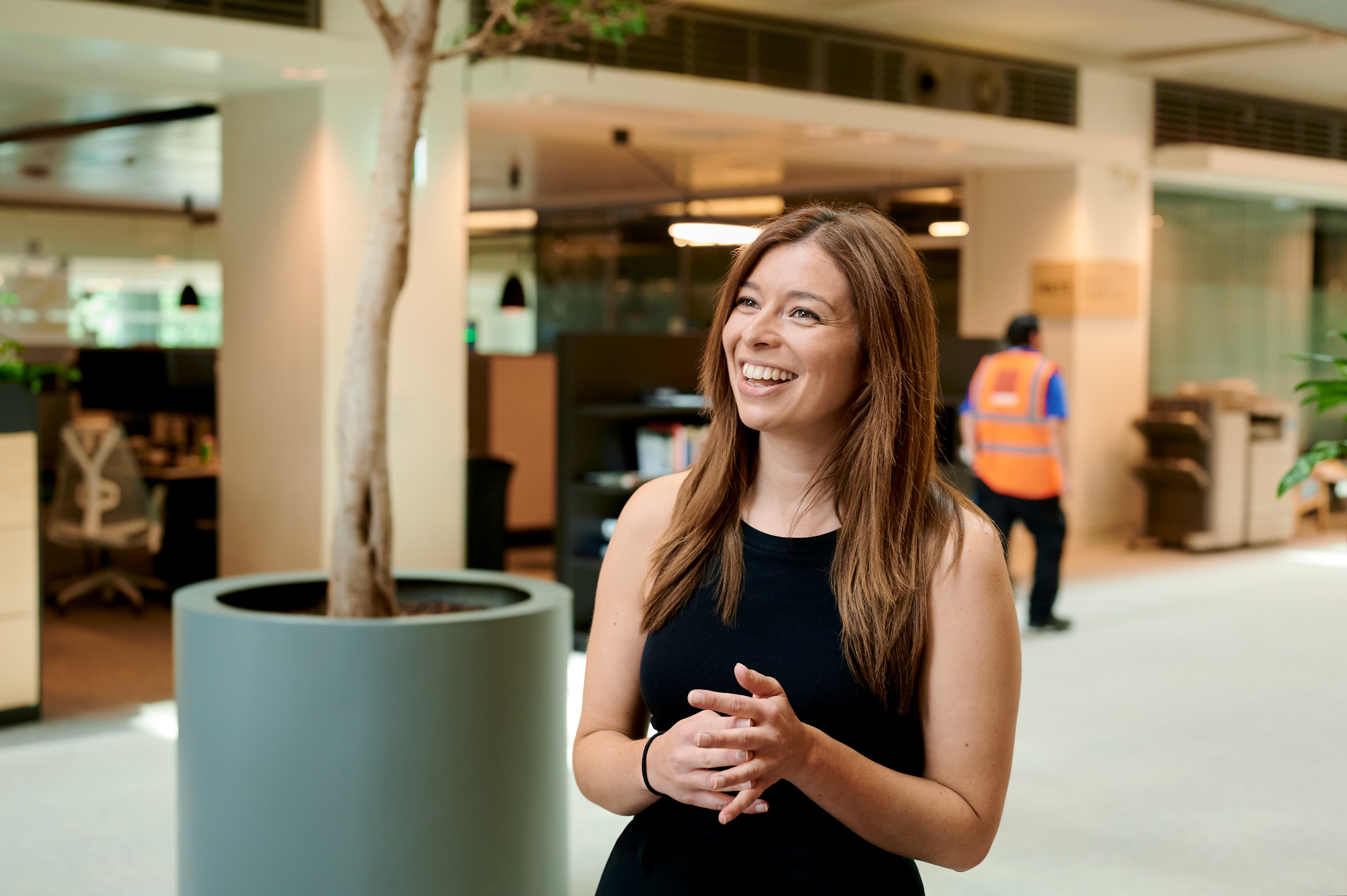 A headshot photo of Sarah who works for Cancer Research UK. She's smiling and looks happy.