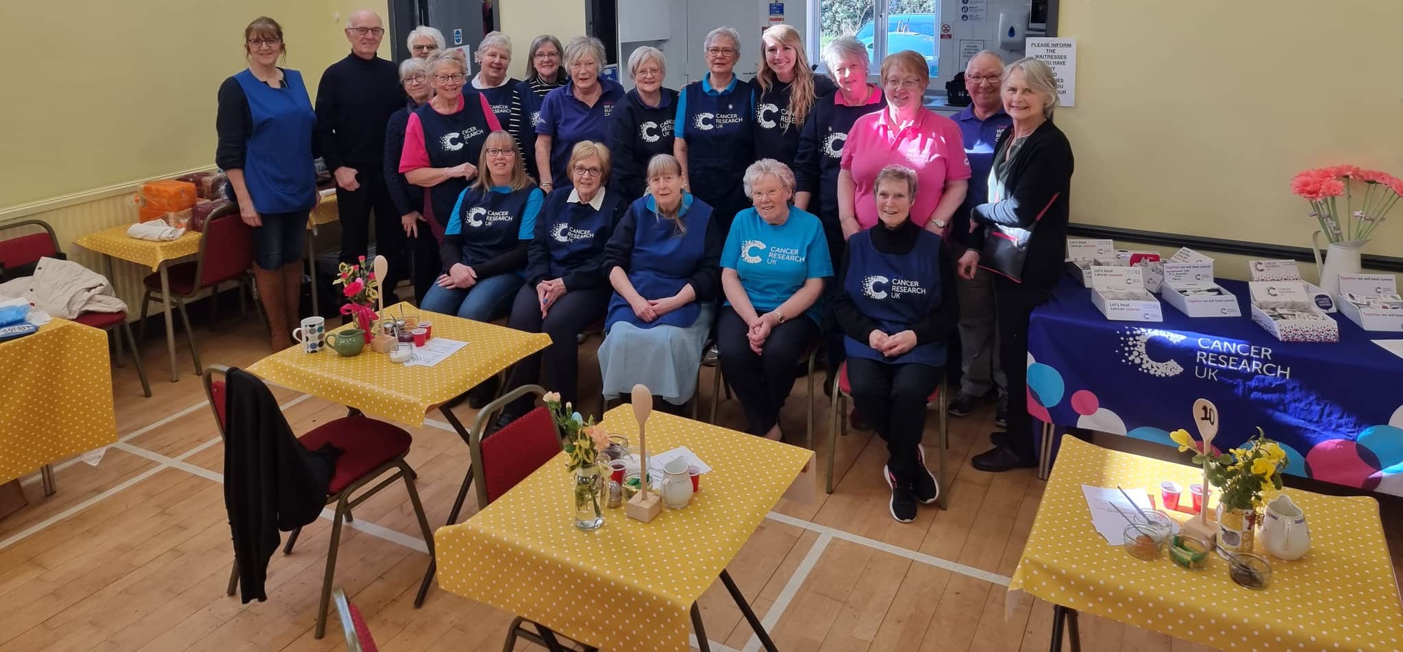 Group photo of Halesworth local committee members sitting together in a community hall.