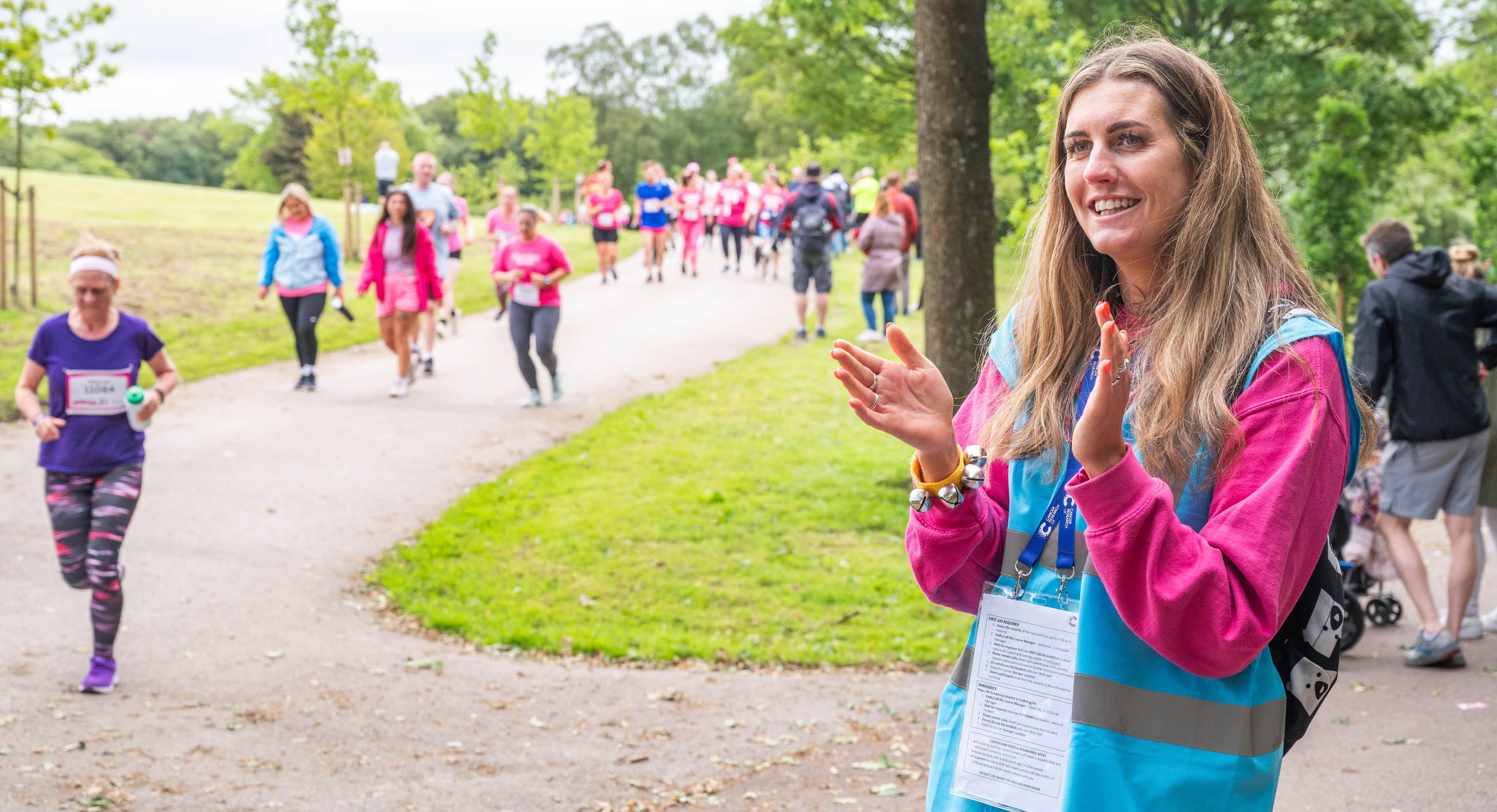 Image of volunteer cheering on race for life participants.