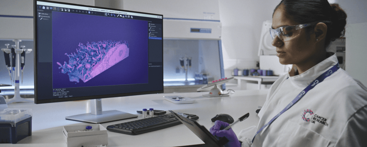 Photo of one of our tireless researchers working in a lab.