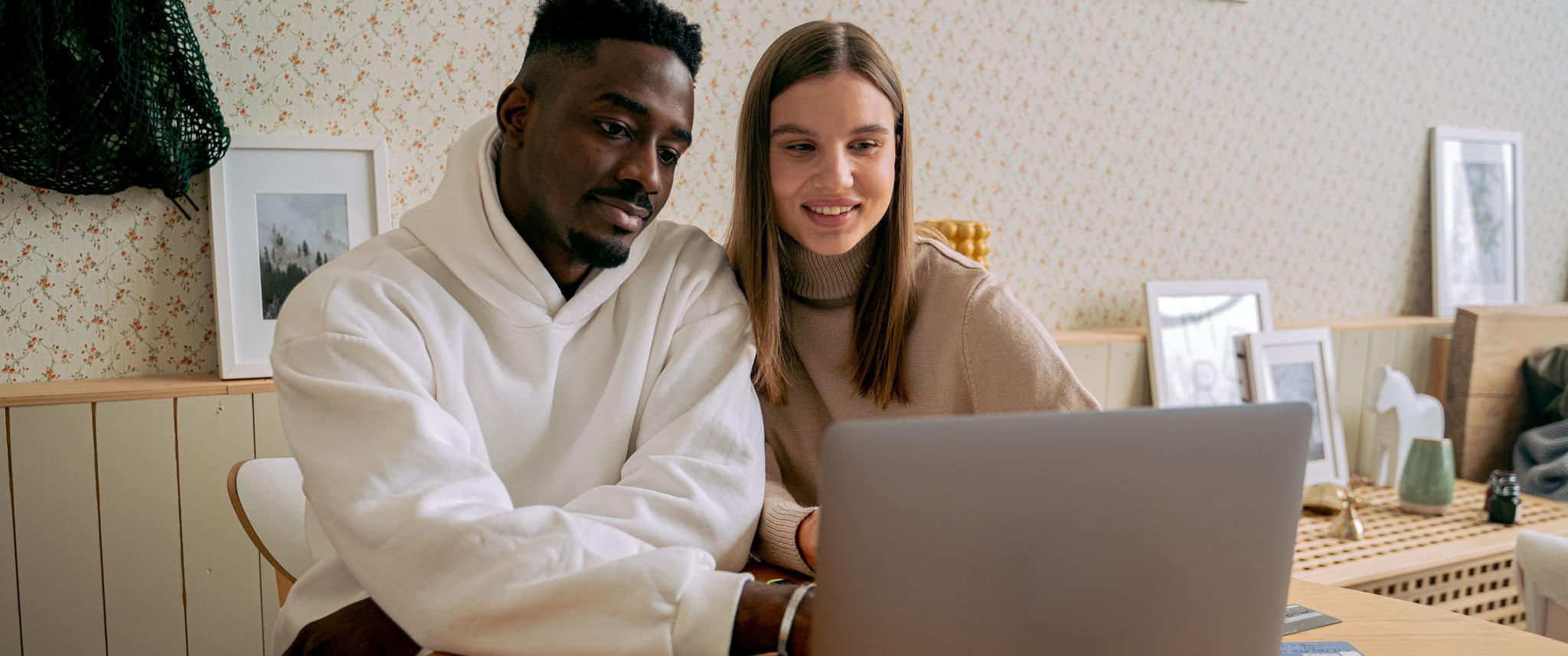 Man and woman looking at a laptop.