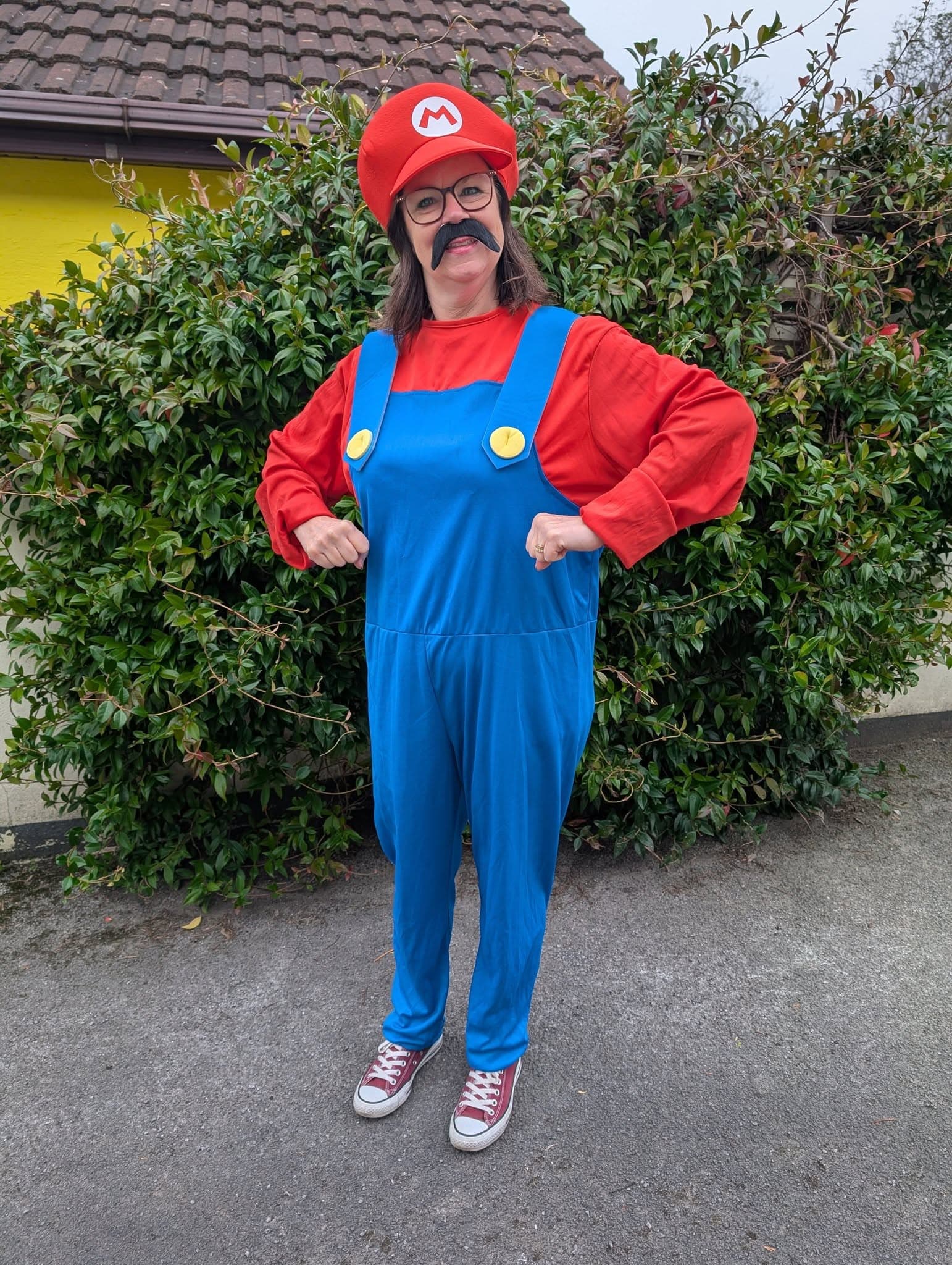 Supporter smiling wearing a Super Mario costume.