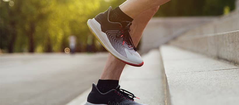 Close up image of trainers running up stairs.
