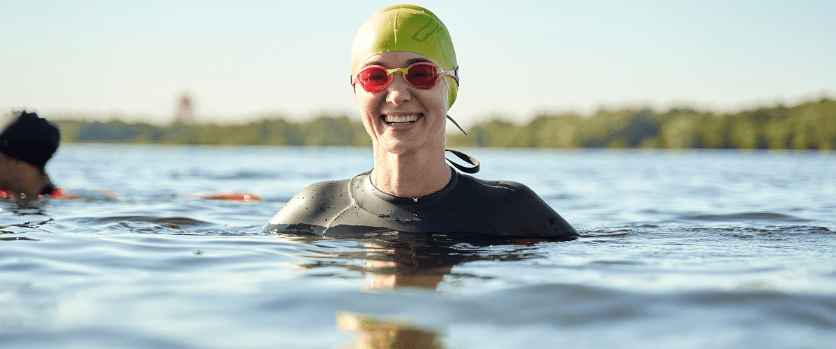 A photo of a swimmer smiling.