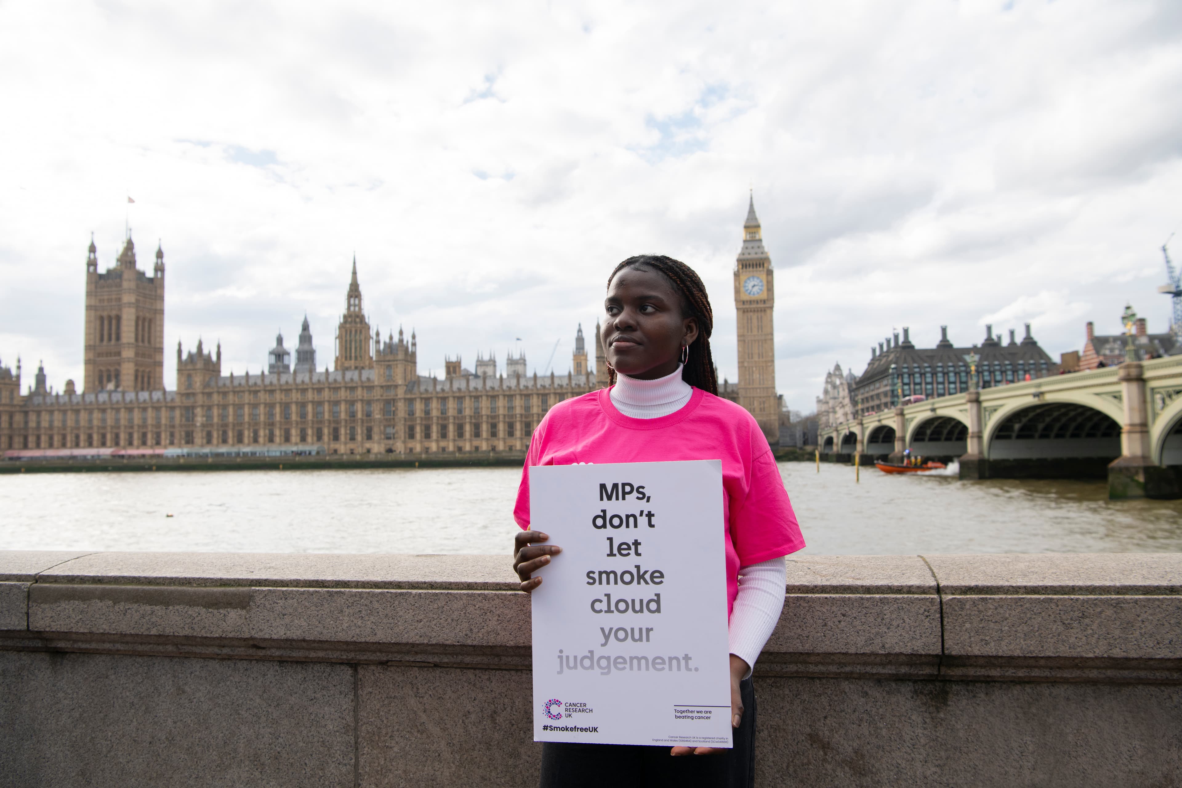 A photo of a Campaigns Ambassador in front of the House of Parliament in London.