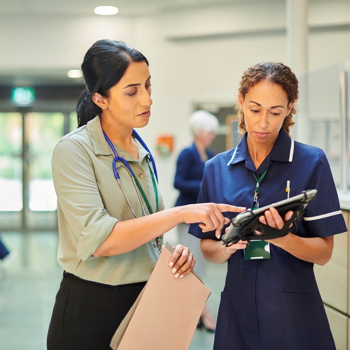 A nurse and a clinician are having a conversation.