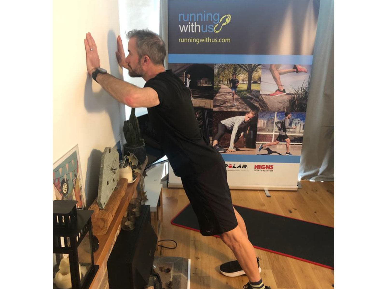 A person doing a wall push-up.