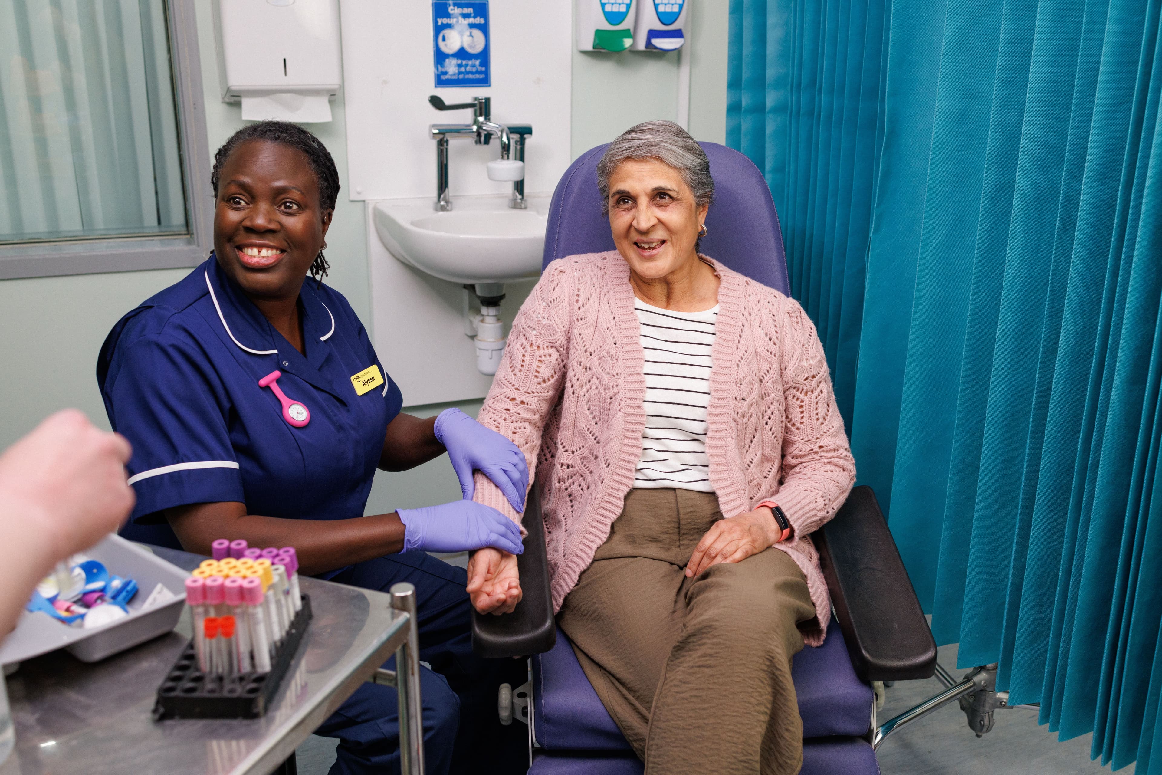 a nurse preparing to draw blood from a patient.