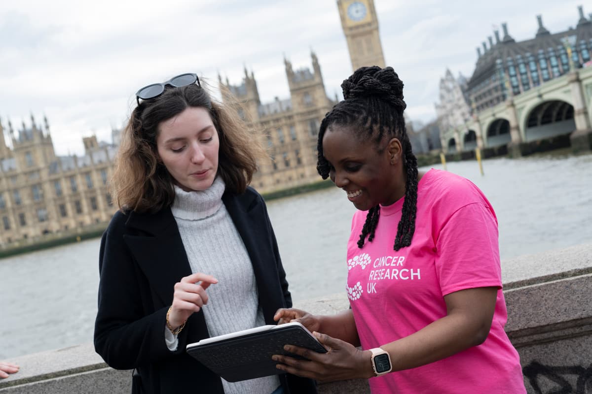 campaigners on riverside, Woman talking and smiling.