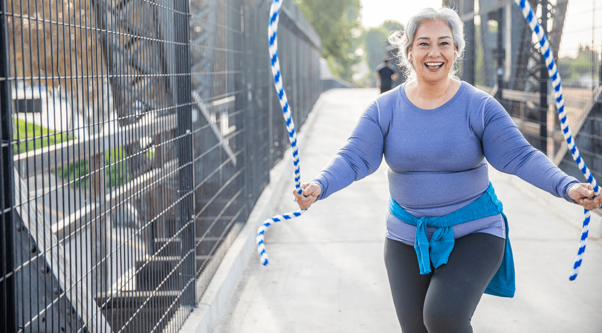 Image of woman skipping smiling.