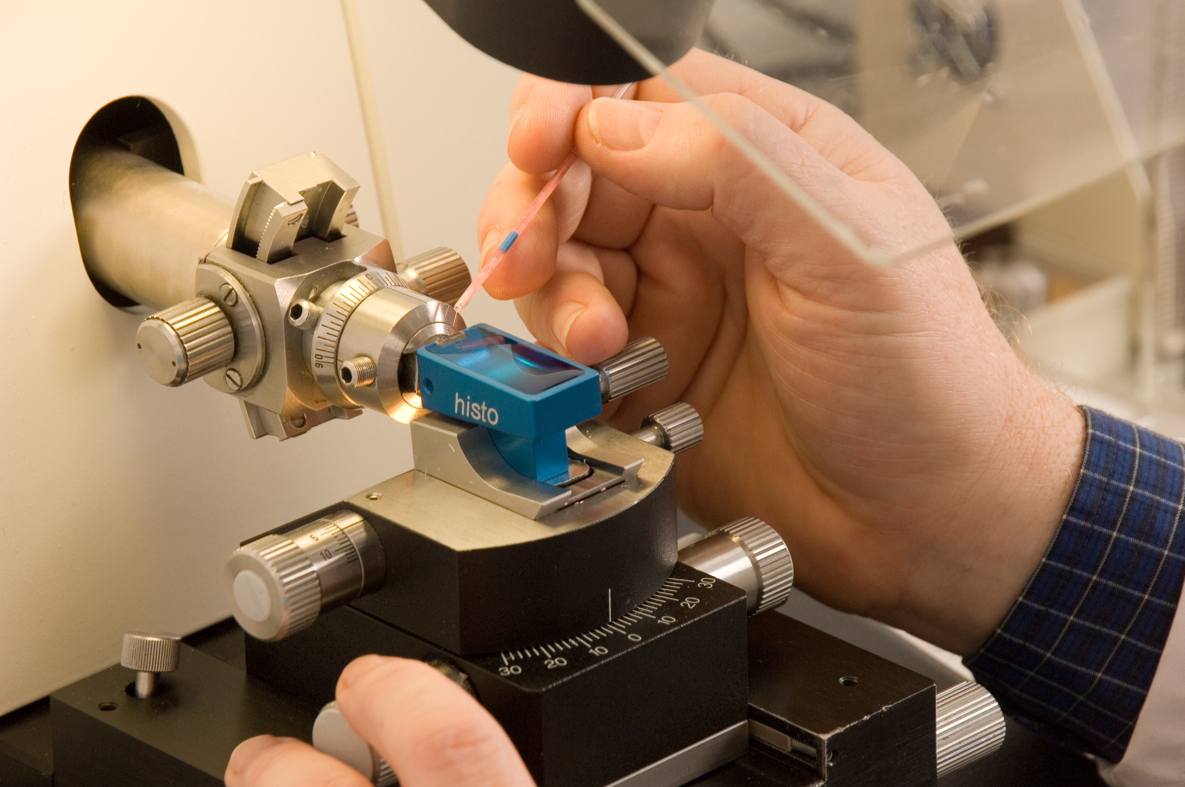 A scientist using a microscope.