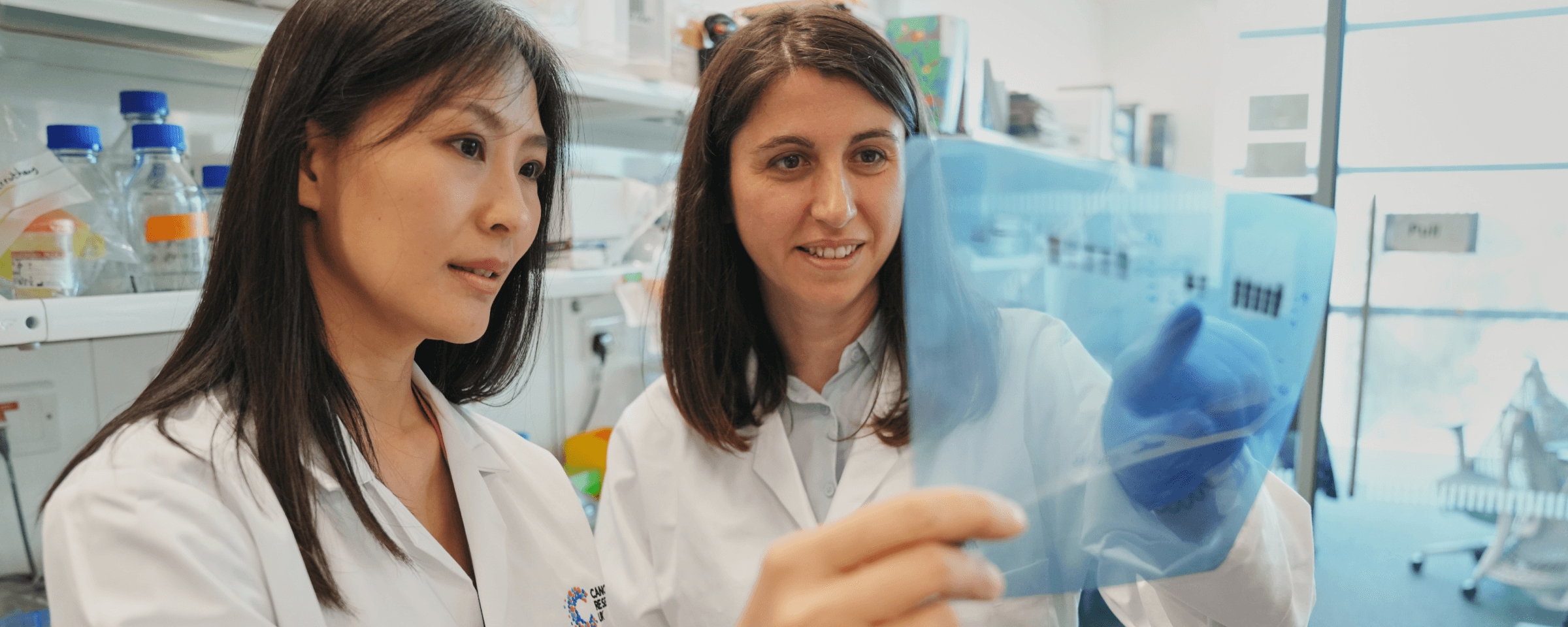 Researchers in the lab looking at a slide.