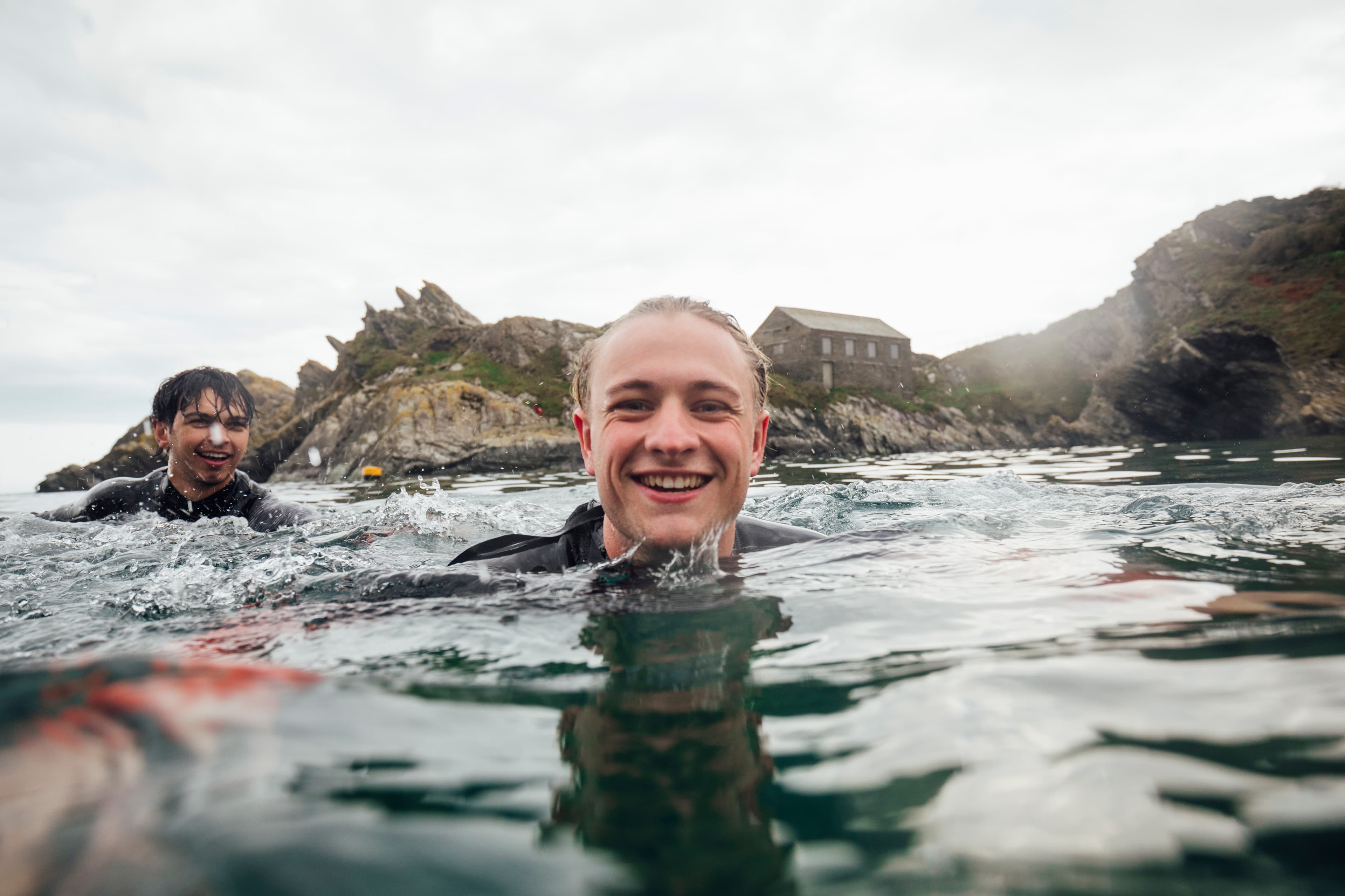 Close-up shot of a man smiling in open water.