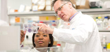 Research scientists looking at a slide