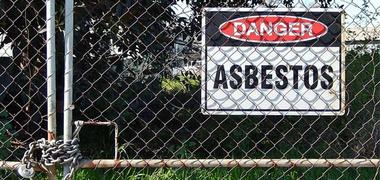 Danger asbestos sign on a fence