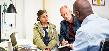 A woman and her partner during a consultation with a doctor