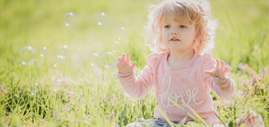 A child playing in grass