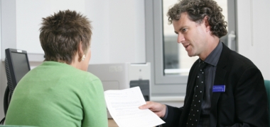 A male doctor talking to a female patient