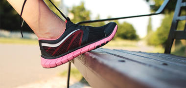 A person tying up trainer laces