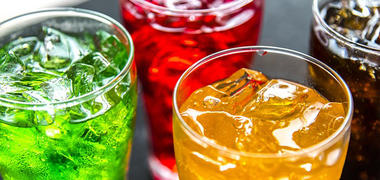 Different coloured fizzy drinks in glasses