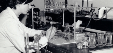 Black and white photograph of a scientist working in an old laboratory