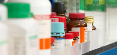 Bottles of chemicals on a lab shelf