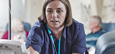 Nurse giving cancer treatment