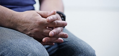 A patient's hands on their lap