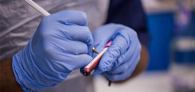 A person writing on a test tube