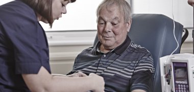 A man receiving treatment from a female nurse