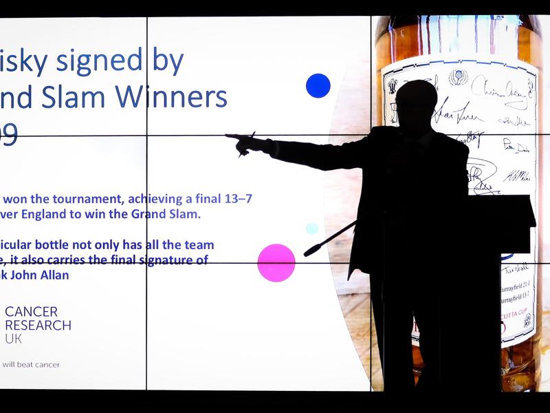 Presenter presenting slide at the Business Beats Cancer Edinburgh dinner