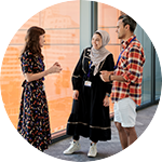 three people standing in an office, talking