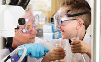Kid and scientist doing an experiment