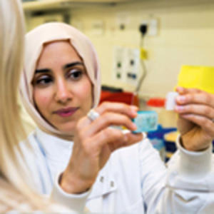 A scientist looking at samples in a lab