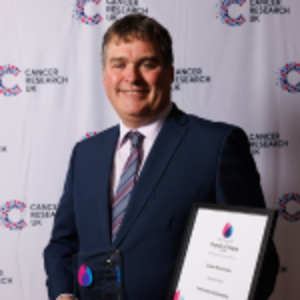 Jason holding his Flame of Hope certificate and trophy