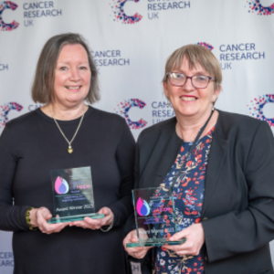 Jenny and Janet holding award trophies