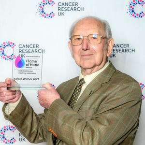John holding his Flame of Hope trophy