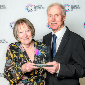 Karen and Philip holding their Flame of Hope trophy