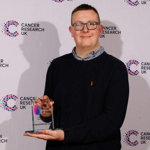 Kieran holding his Flame of Hope trophy